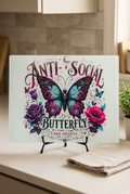 Anti-Social Butterfly glass cutting board displayed on a kitchen countertop